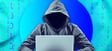 Man in hoodie using laptop