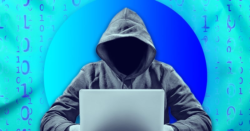 Man in hoodie using laptop